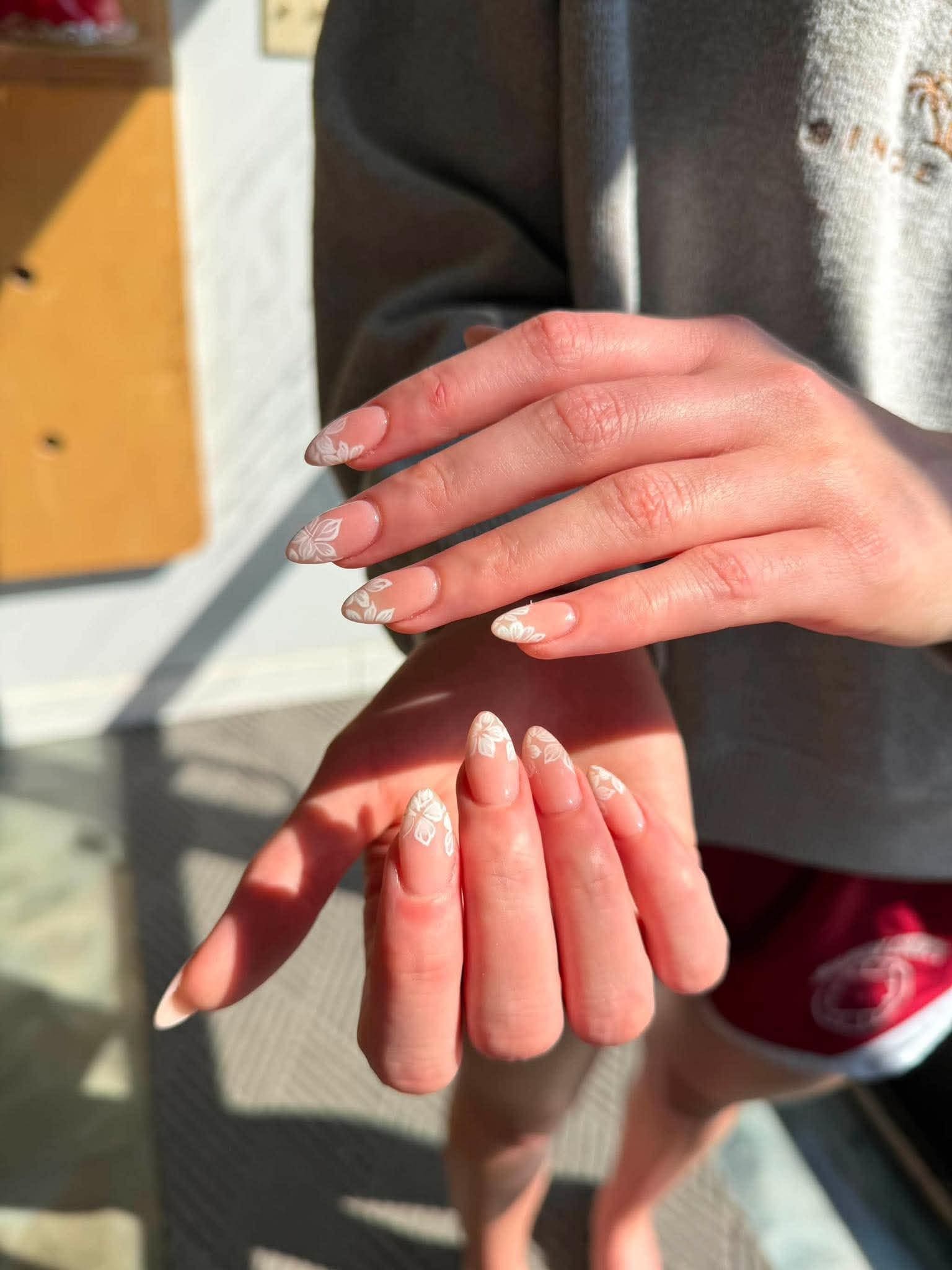 Almond nails with hand-painted white floral tips